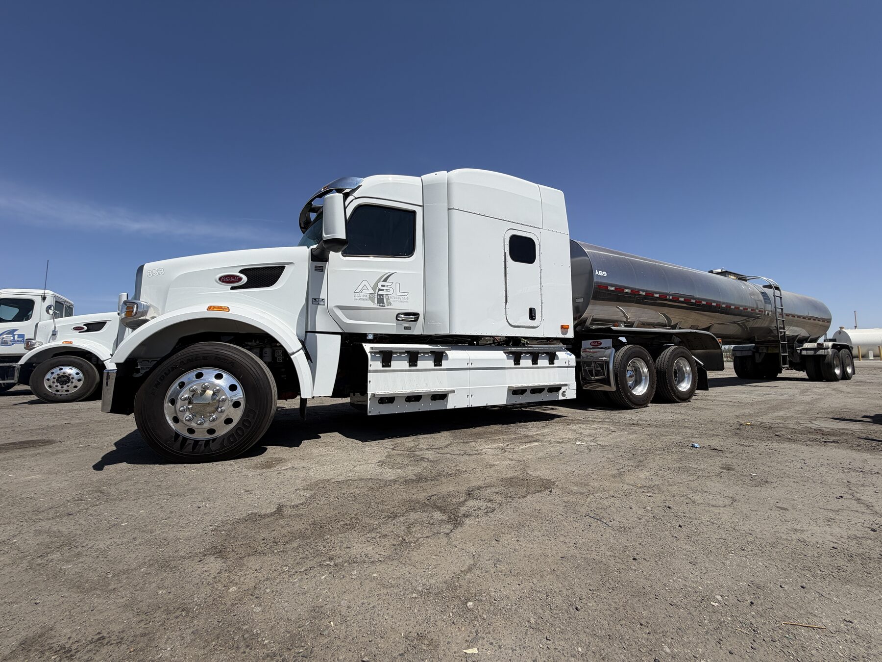 Side view of an All Seasons Logistics stainless steel milk tanker
